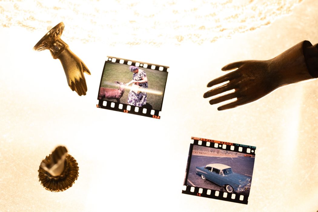 hands holding film negatives to the light