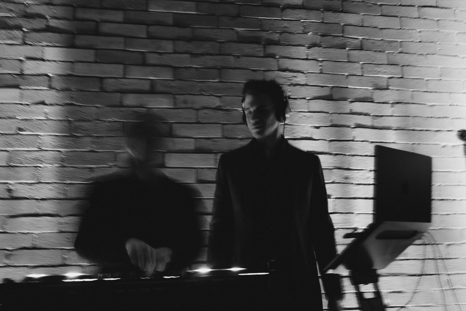 guests in silhouette against the brick wall