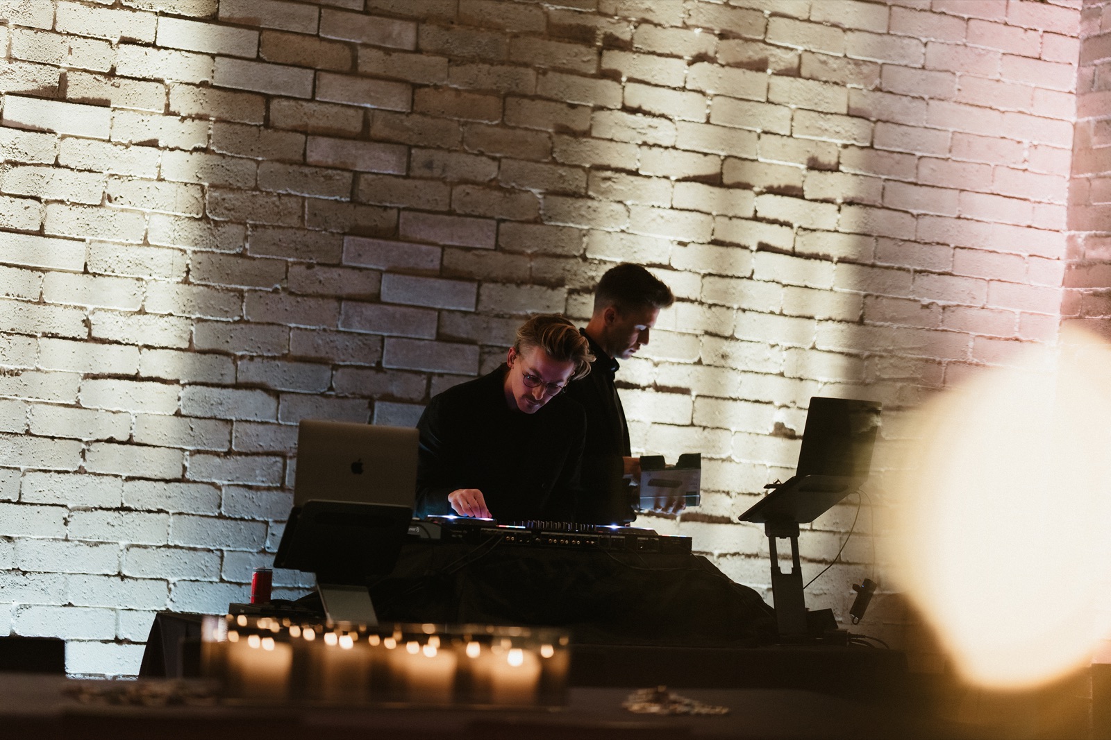 guests dancing under warm light at a wedding reception
