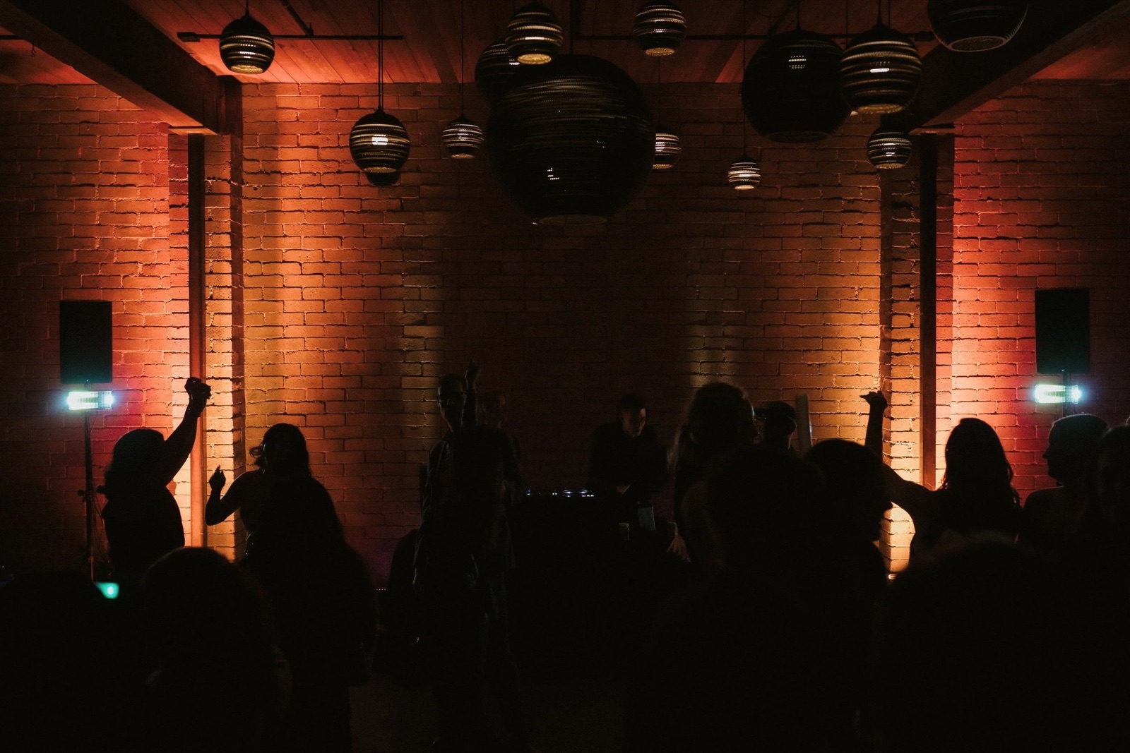 amber light on the brick wall above the crowd