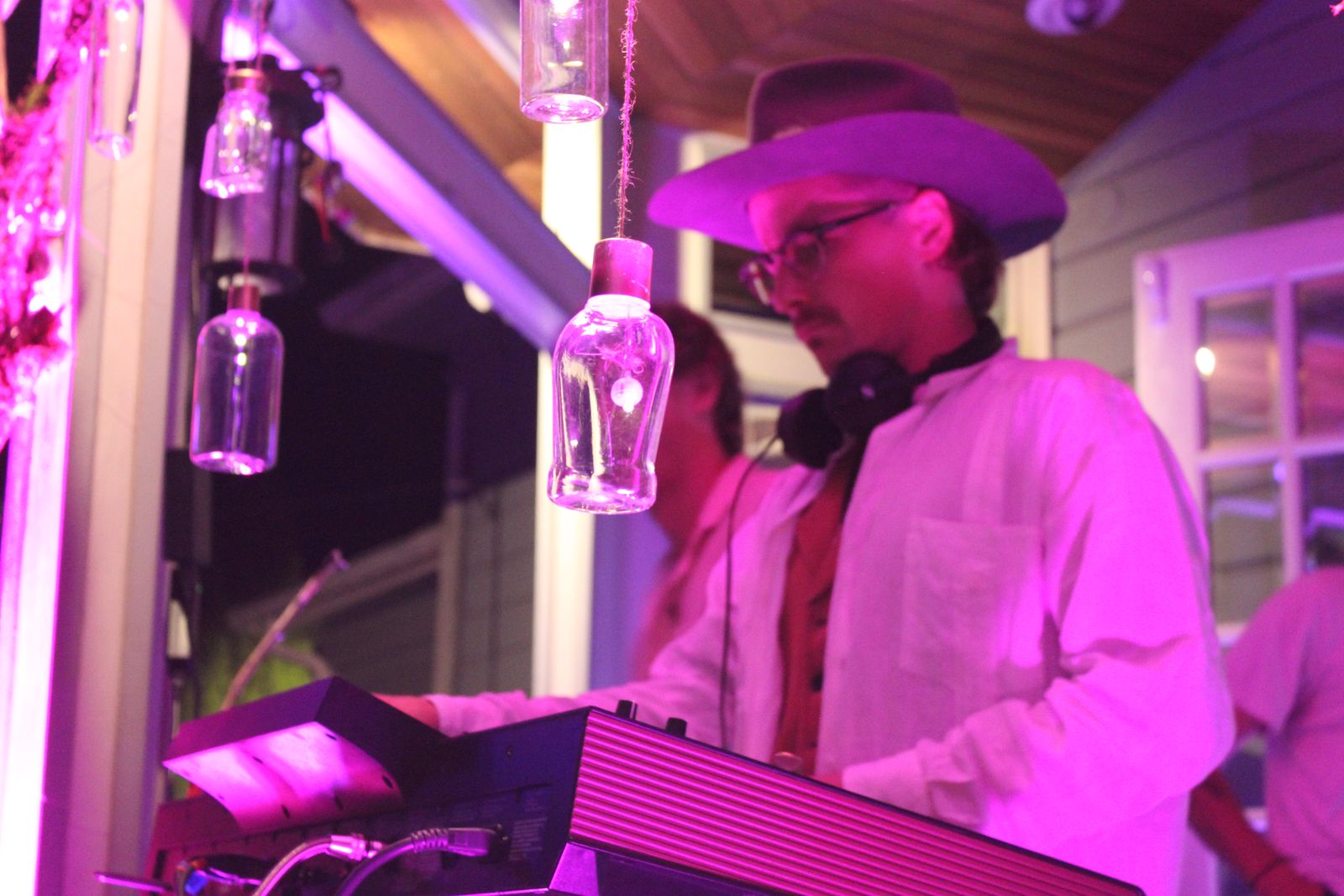 the dj at the decks under magenta light, the boiler-room booth
