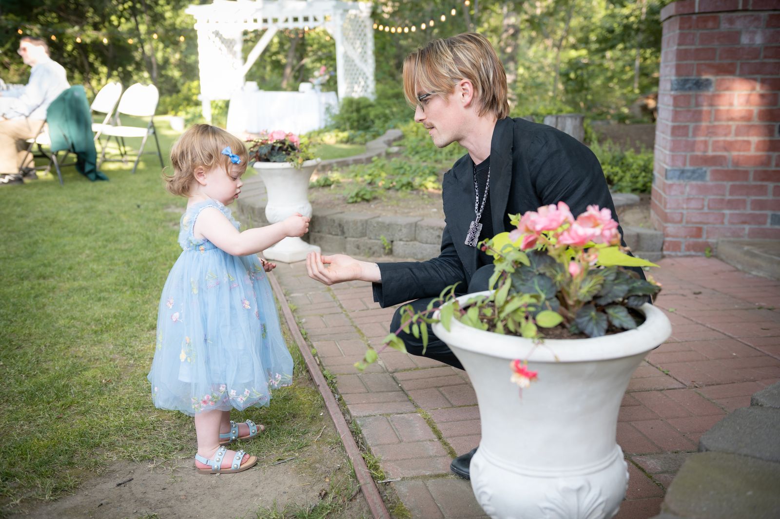 a flower girl by a garden planter in daylight